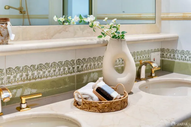 a bathroom with a granite countertop sink a toilet a mirror a bathtub and shower