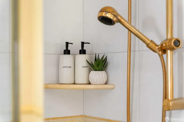 a bathroom with a sink a toilet a mirror and shower