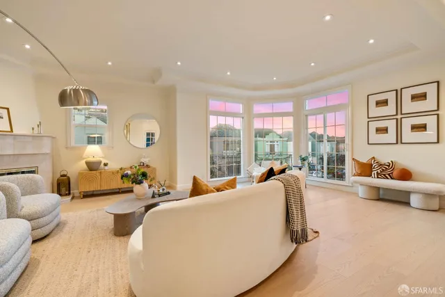 a dining room with furniture a chandelier and wooden floor