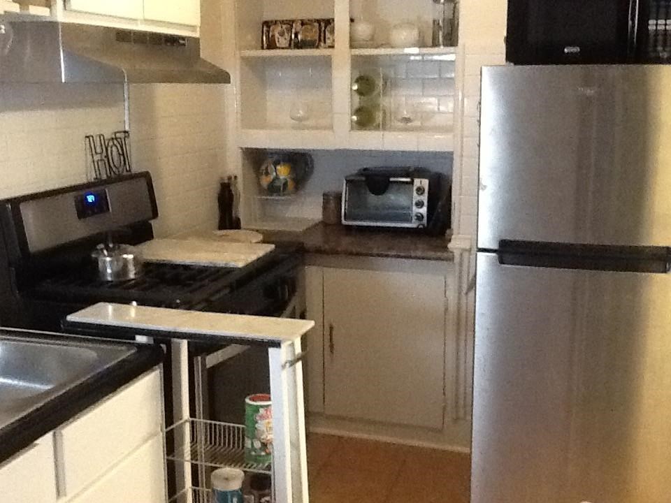 147 North Rembert Street Memphis, TN 38104 - Photo 14 of 25 a kitchen with a refrigerator and a stove top oven