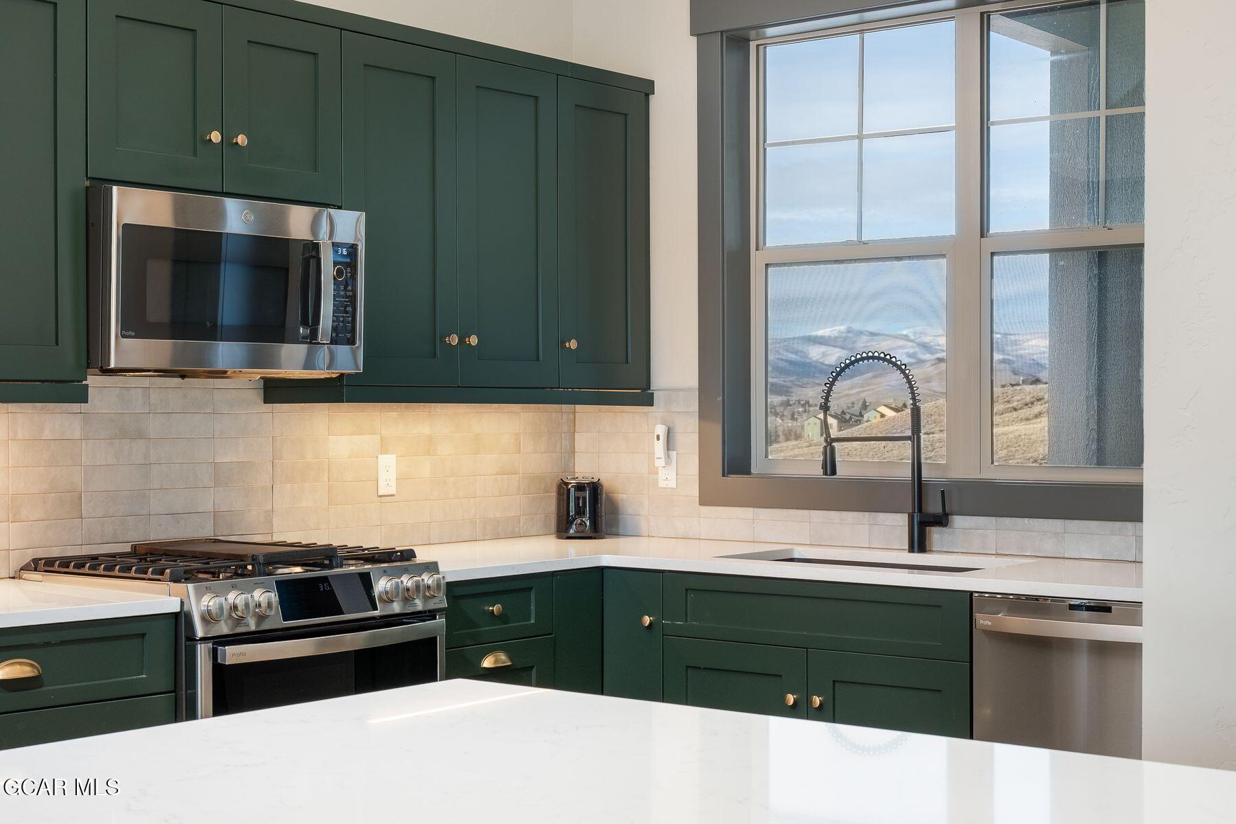 102 Eagle Ridge Drive Granby, CO 80446 - Photo 12 of 44 a kitchen with a sink stove and microwave