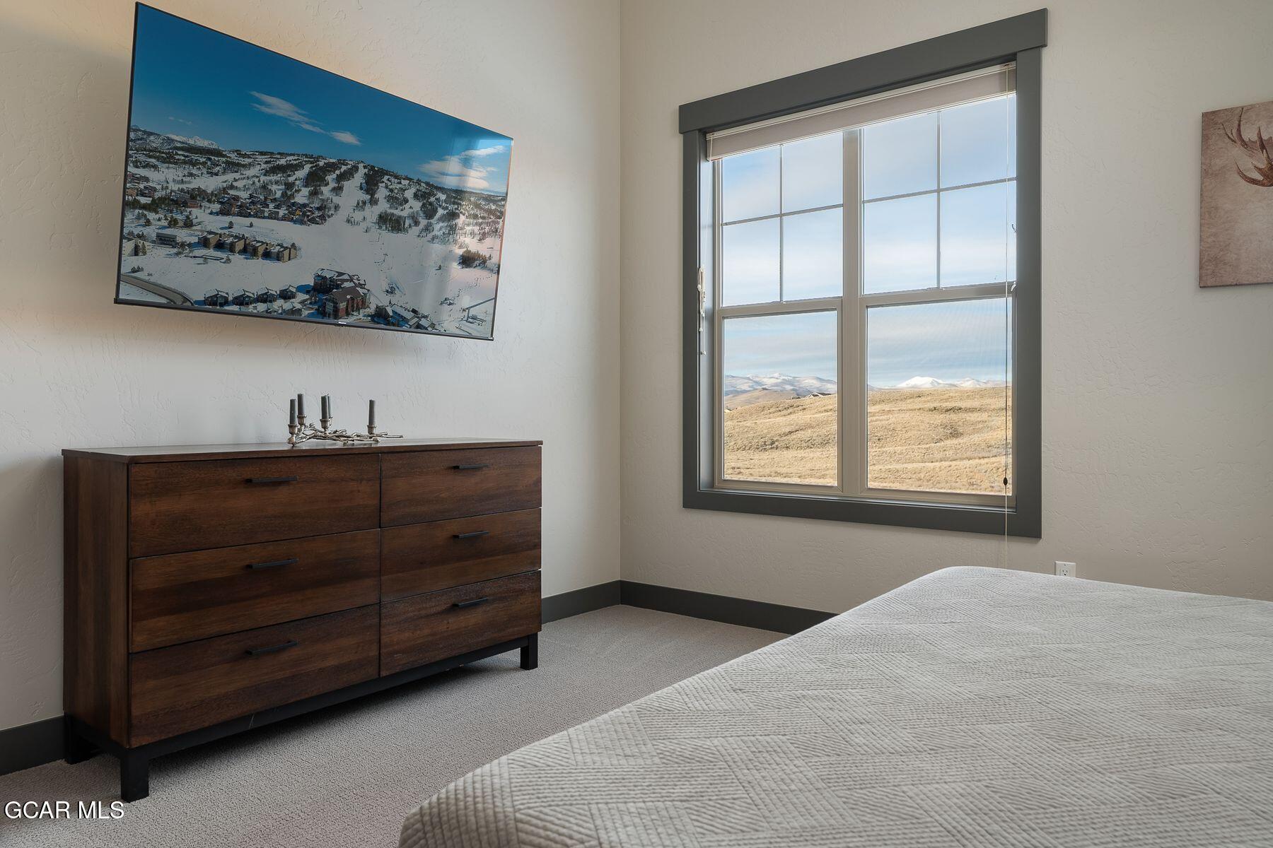 102 Eagle Ridge Drive Granby, CO 80446 - Photo 15 of 44 a bedroom with a bed and a window