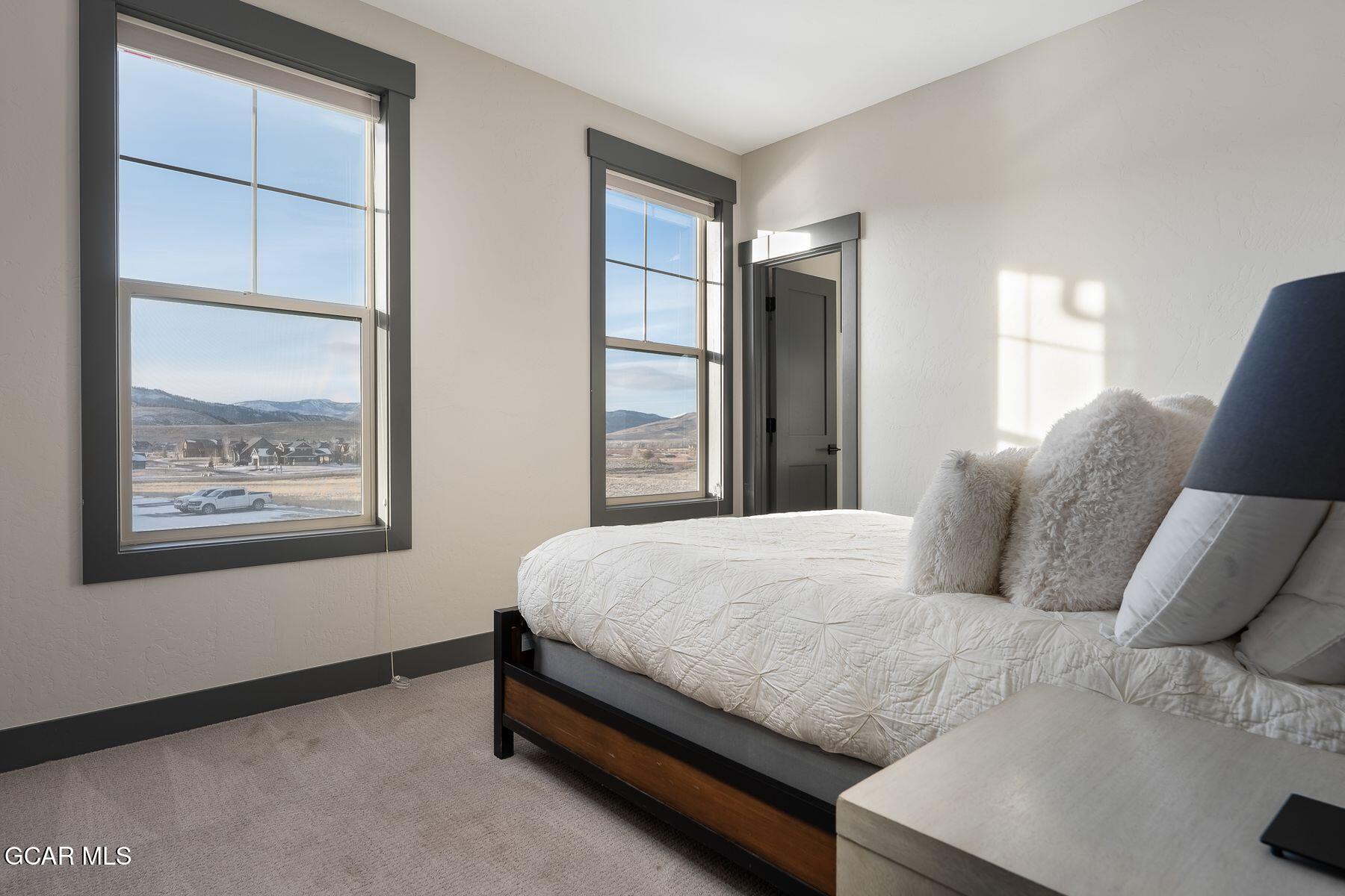 102 Eagle Ridge Drive Granby, CO 80446 - Photo 16 of 44 a bedroom with a bed and a window