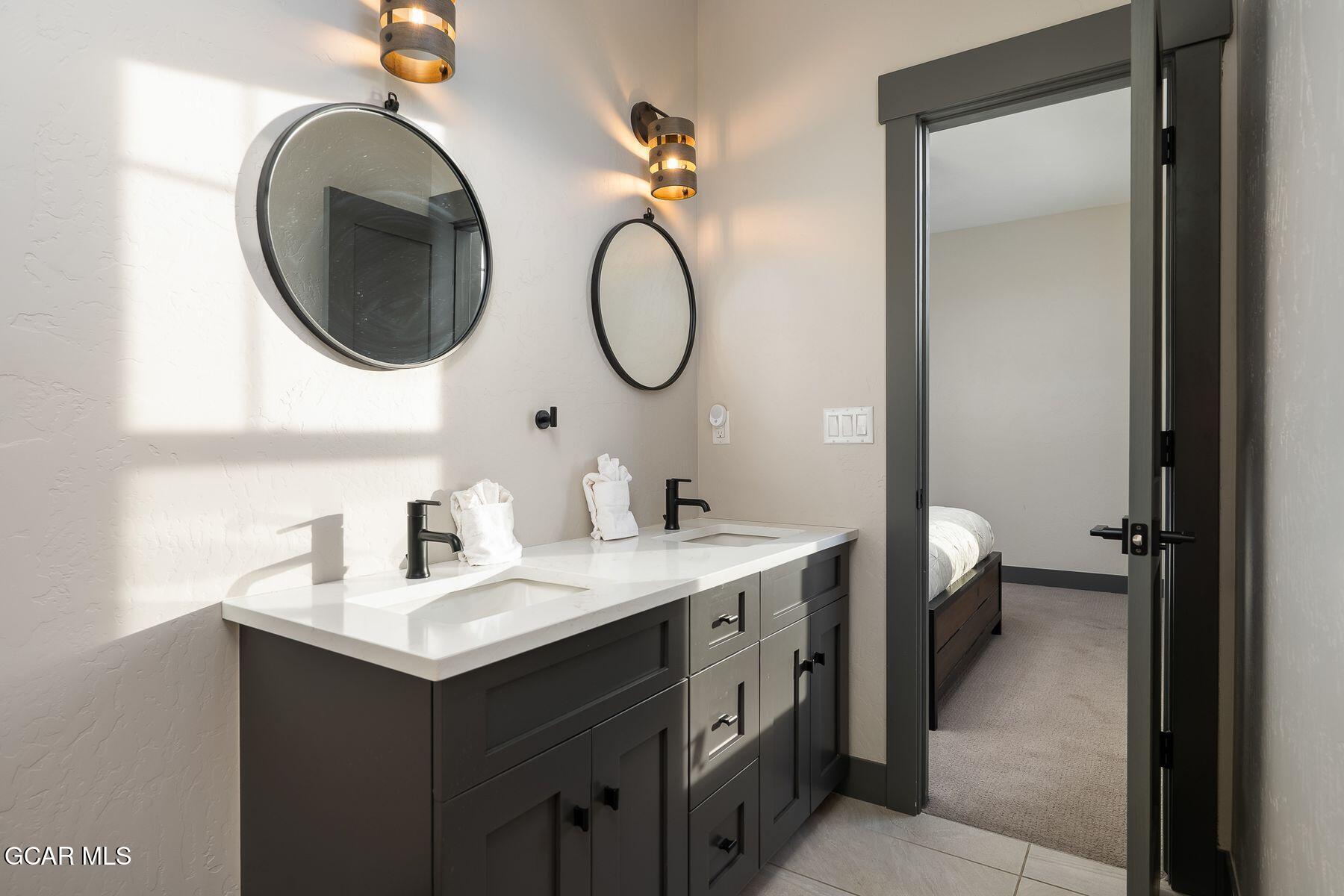 102 Eagle Ridge Drive Granby, CO 80446 - Photo 19 of 44 a bathroom with a toilet sink and mirror