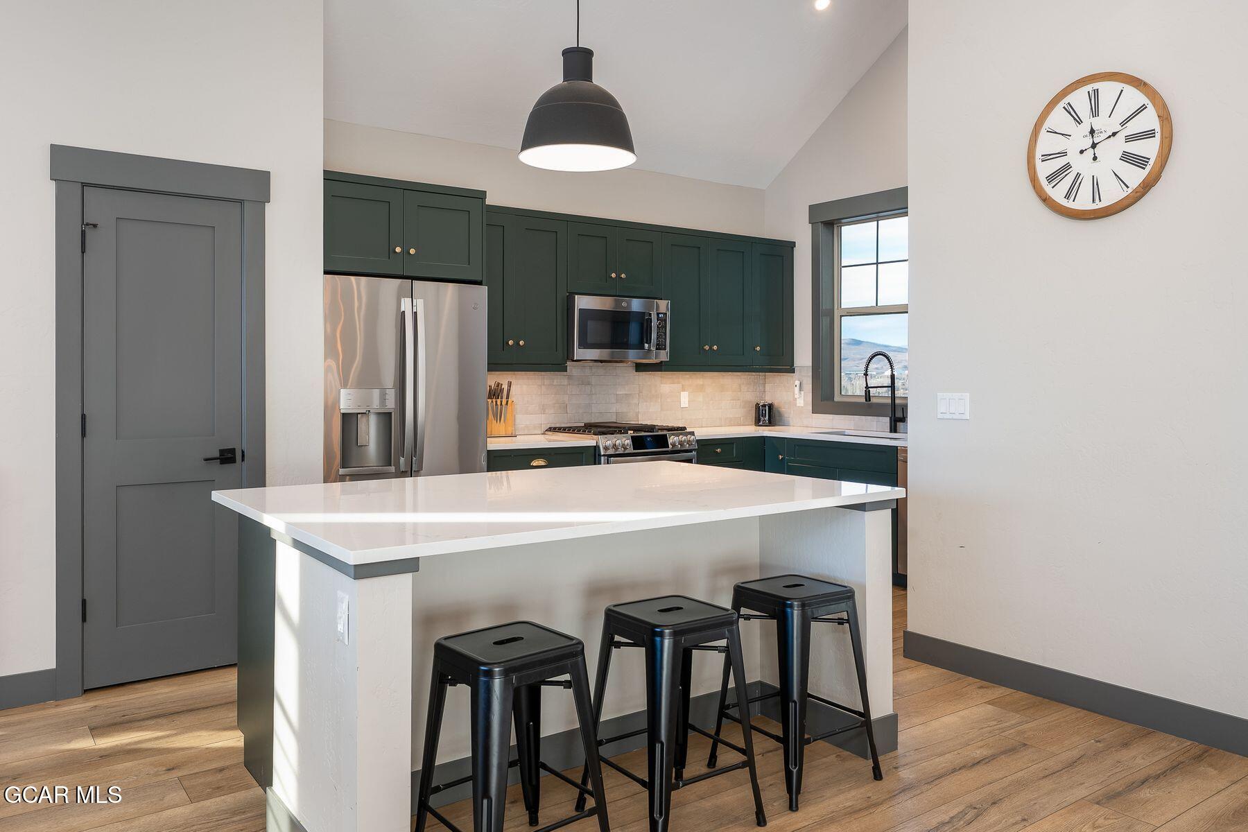 102 Eagle Ridge Drive Granby, CO 80446 - Photo 3 of 44 a kitchen with stainless steel appliances a table and chairs
