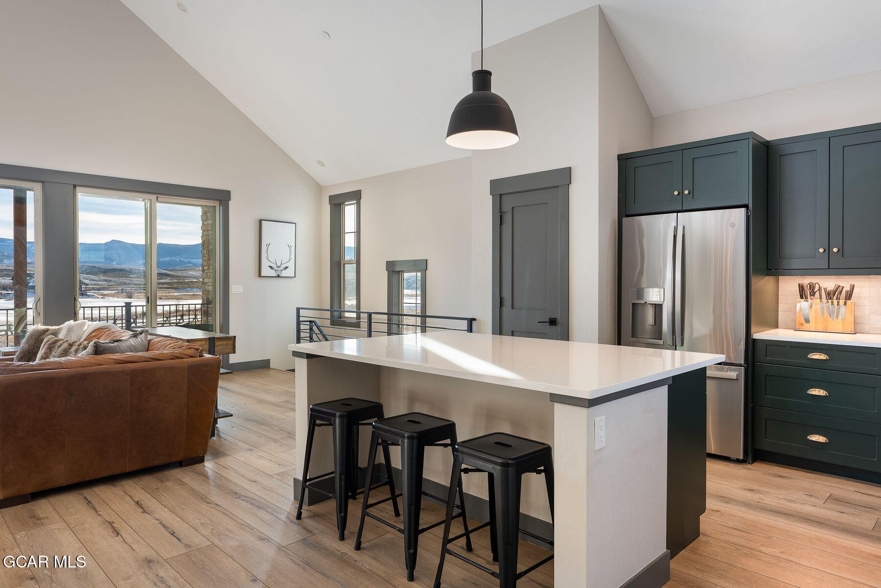 102 Eagle Ridge Drive Granby, CO 80446 - Photo 8 of 44 a large kitchen with kitchen island a island a sink a stove and a refrigerator