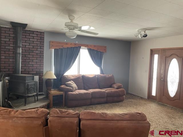 16424 Bull Mesa Road Cedaredge, CO 81413 - Photo 5 of 11 a living room with furniture and a window