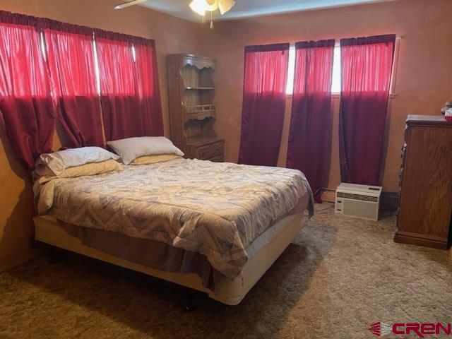 16424 Bull Mesa Road Cedaredge, CO 81413 - Photo 8 of 11 a bed sitting in a spacious bedroom next to a window