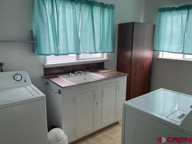 16424 Bull Mesa Road Cedaredge, CO 81413 - Photo 10 of 11 a utility room with dryer and washer