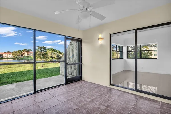 a view of a big room with wooden floor fan and windows