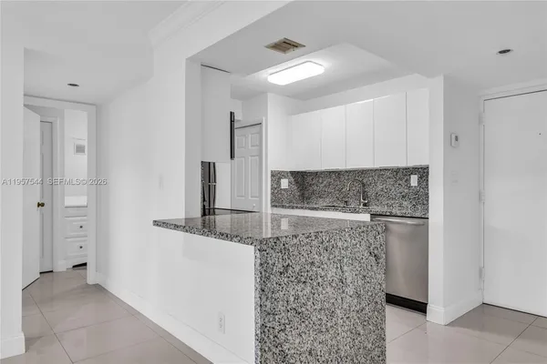 a bathroom with a granite countertop sink a toilet and a mirror
