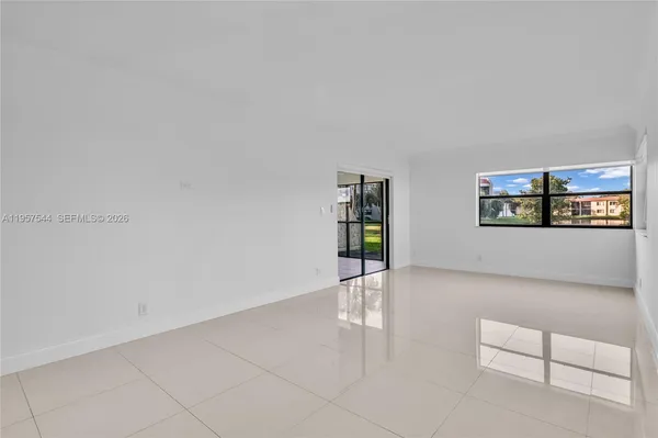 a view of a livingroom with wooden floor and furniture