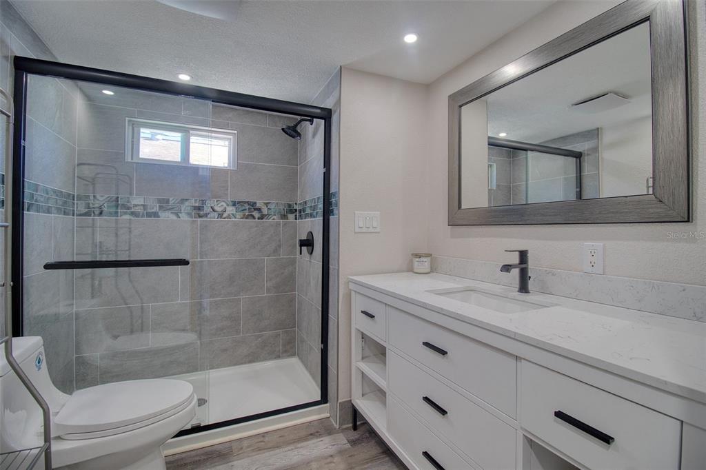 6820 Sea Ranch Drive Hudson, FL 34667 - Photo 15 of 29 a bathroom with a shower sink and mirror