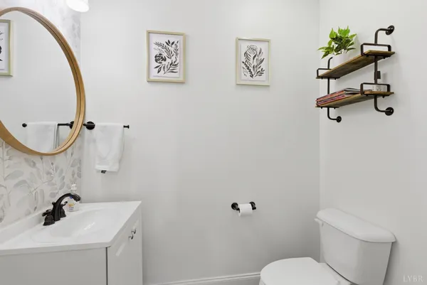 a bathroom with a granite countertop sink mirror and a bathtub