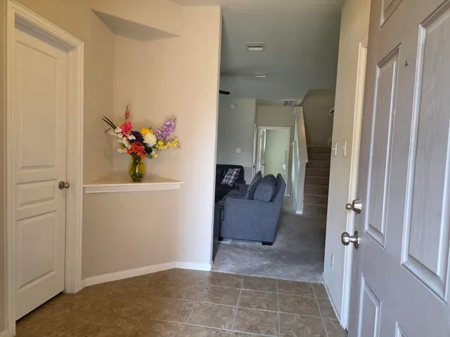a living room with furniture and a large window