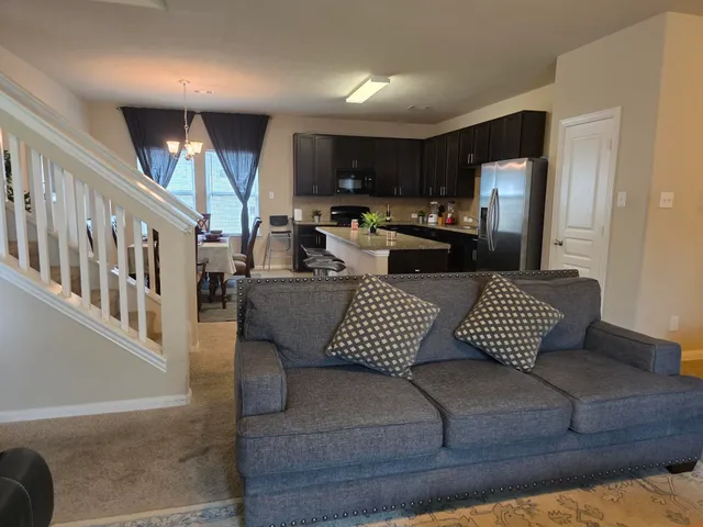 a view of a dining room with furniture and a large window