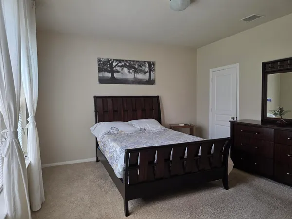a bed sitting in a room next to a window