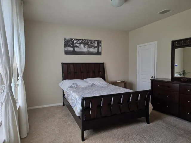 a bed sitting in a room next to a window