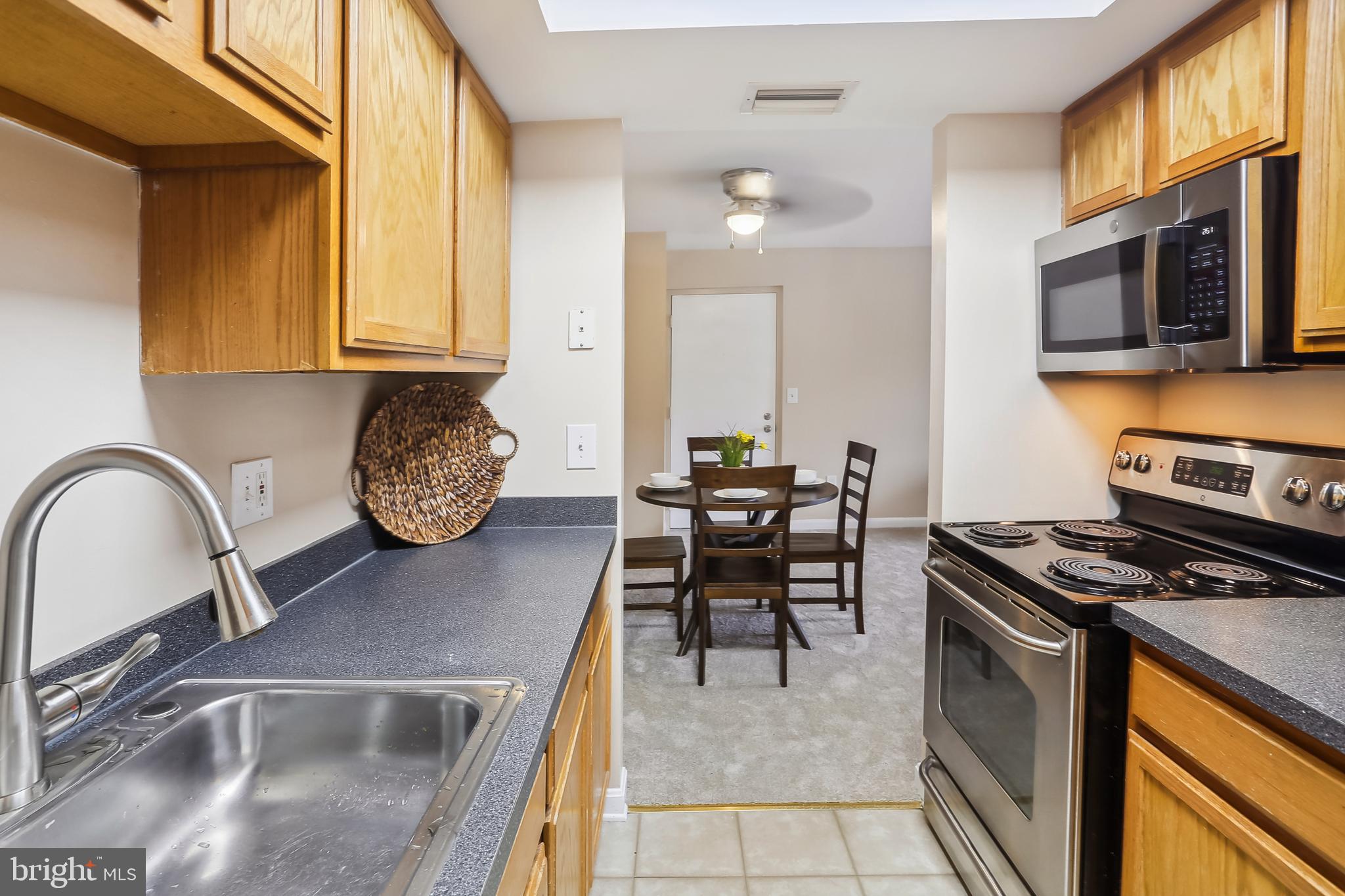 14800 Rydell Road, Unit 201 Centreville, VA 20121 - Photo 22 of 31 Galley Kitchen with Wood Cabinets