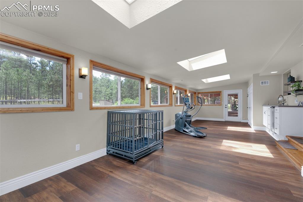 16635 High Tree Drive Elbert, CO 80106 - Photo 20 of 50 an empty room with wooden floor and windows