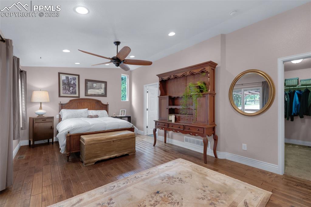 16635 High Tree Drive Elbert, CO 80106 - Photo 22 of 50 a spacious bedroom with a bed a mirror and a table in it