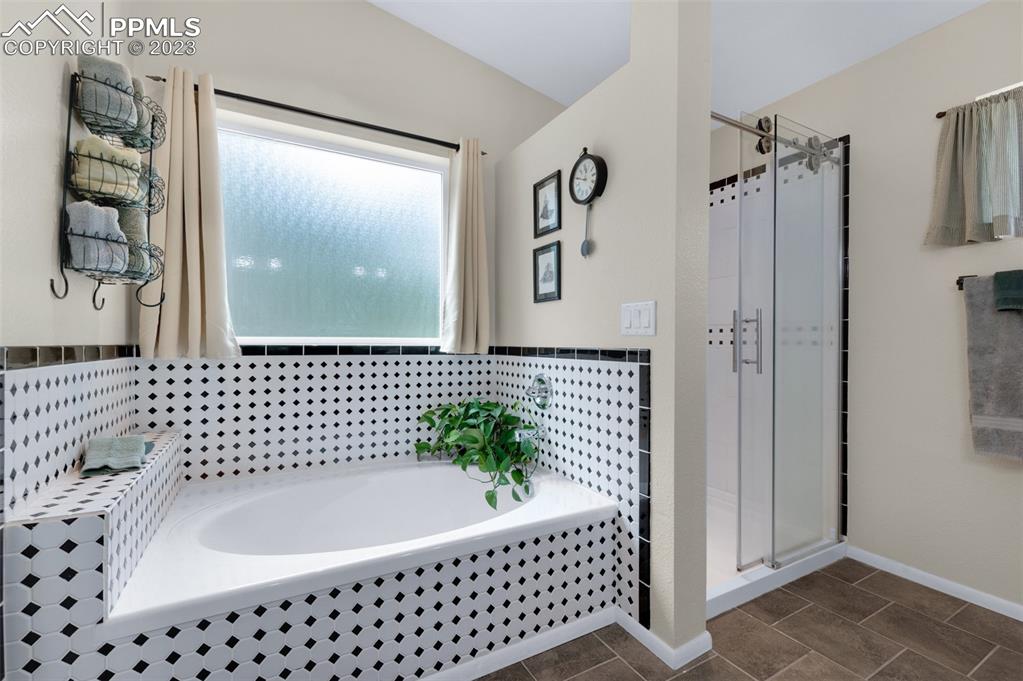 16635 High Tree Drive Elbert, CO 80106 - Photo 26 of 50 a bathroom with a bathtub and shower