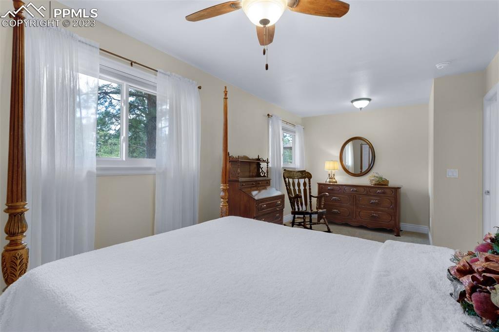 16635 High Tree Drive Elbert, CO 80106 - Photo 32 of 50 a bedroom with a bed and a chandelier