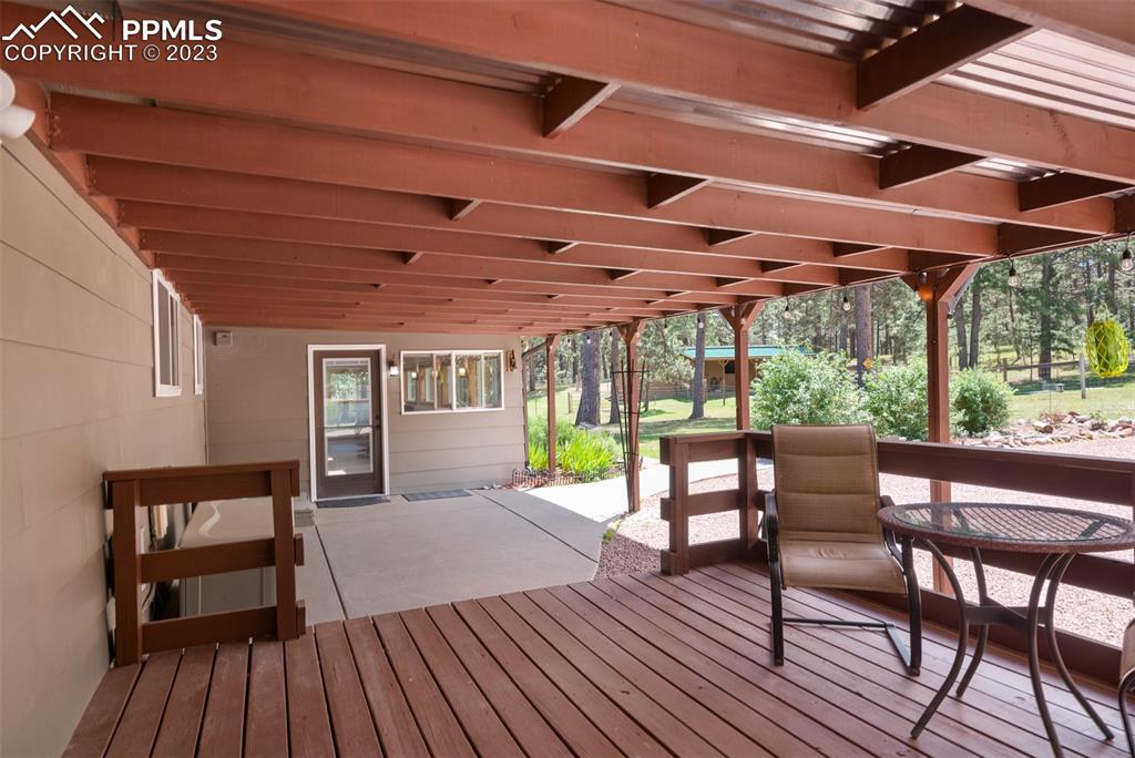 16635 High Tree Drive Elbert, CO 80106 - Photo 34 of 50 a view of a patio with table and chairs and wooden floor