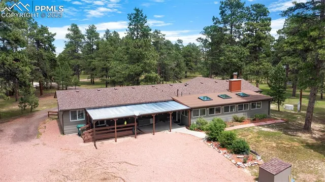 an aerial view of a house with a yard patio and deck
