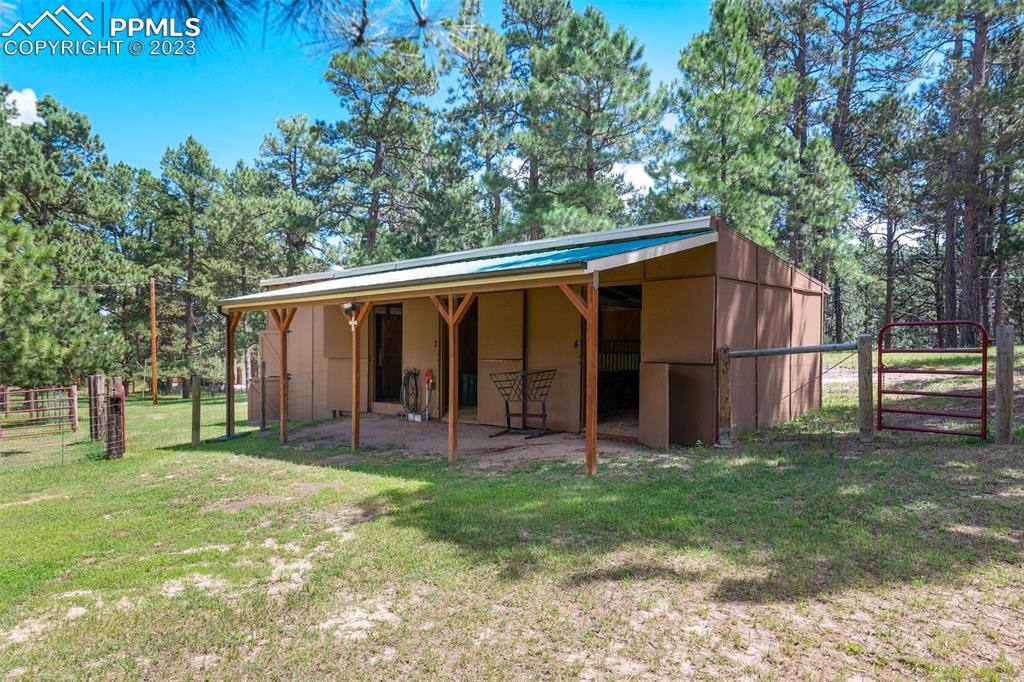 16635 High Tree Drive Elbert, CO 80106 - Photo 9 of 50 a view of a backyard with a large tree and wooden fence