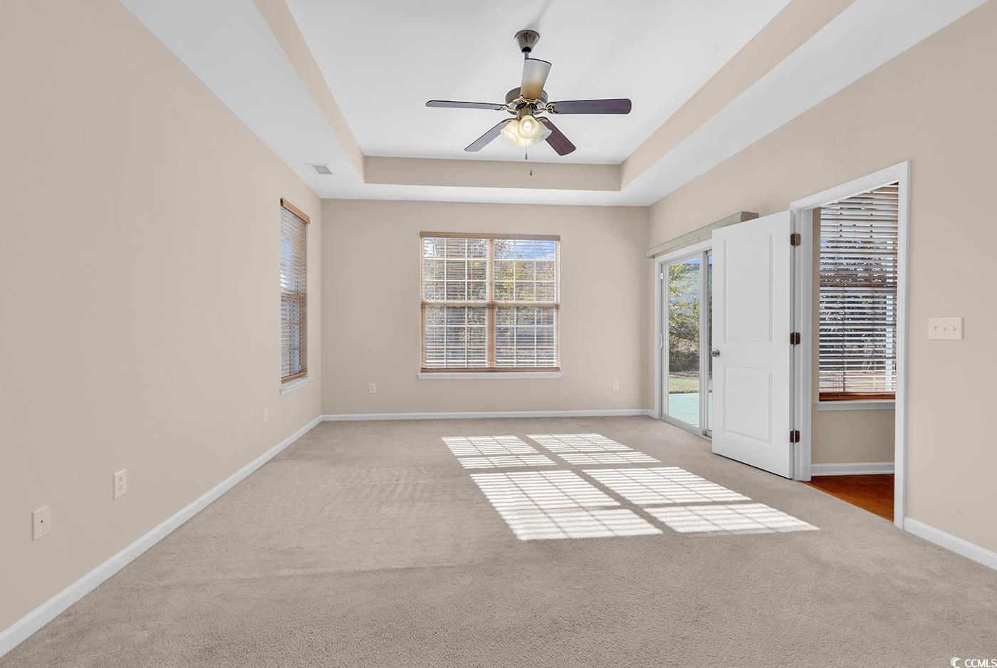 1612 Fairforest Court Conway, SC 29526 - Photo 20 of 40 Carpeted empty room with a tray ceiling and a ceiling fan