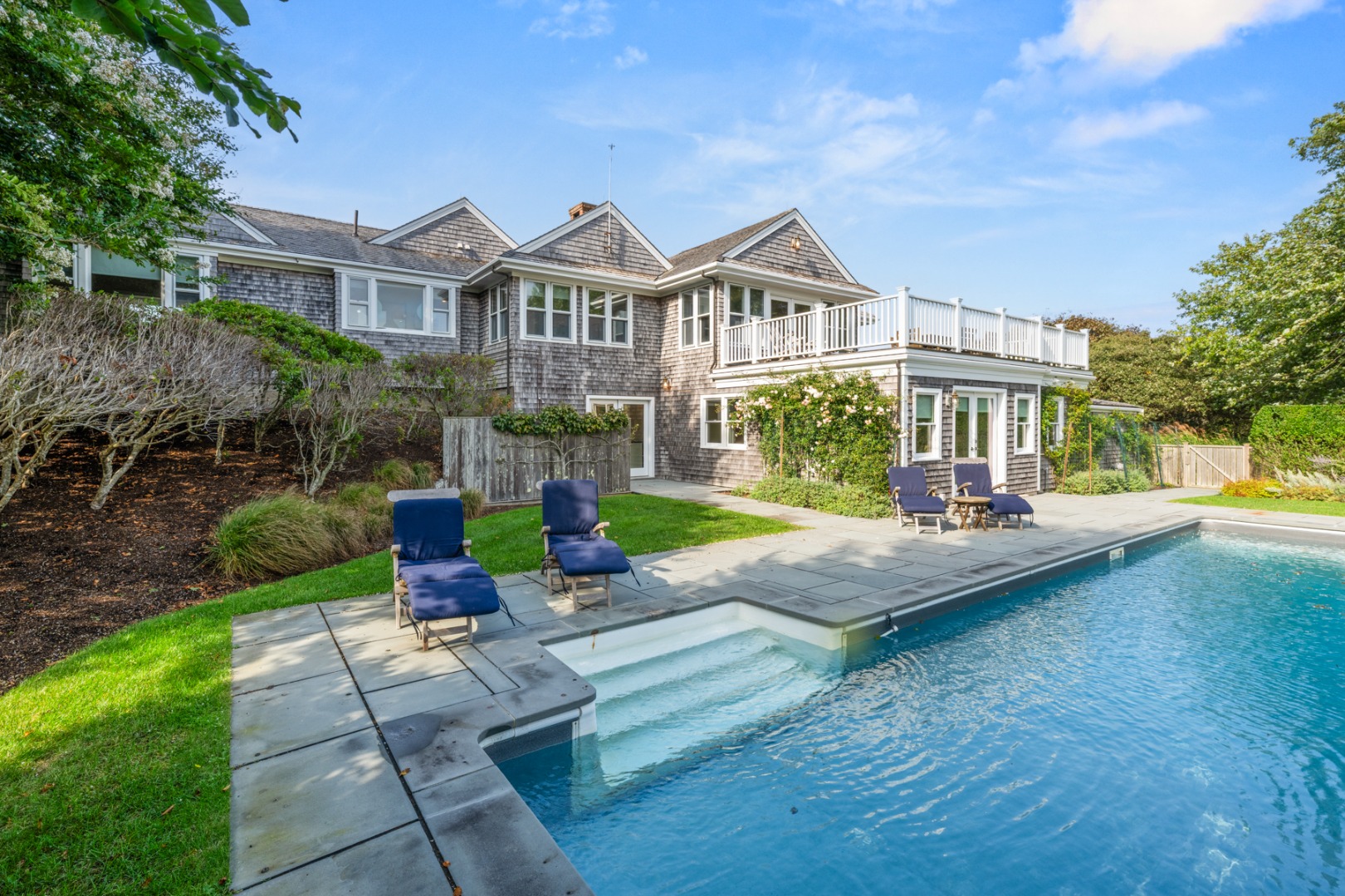 247 Polpis Road Nantucket, MA 02554 - Photo 33 of 52 a front view of a house with garden and sitting area