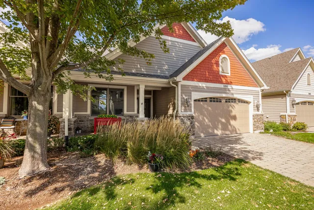 a view of a house with backyard and sitting area