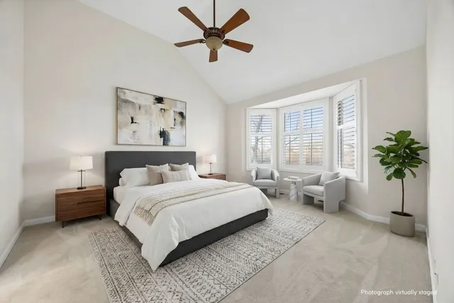 a bedroom with a bed couch and window