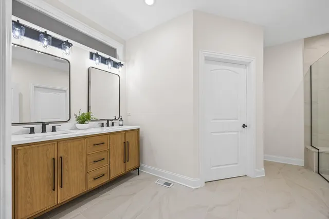 a bathroom with a double vanity sink and mirror