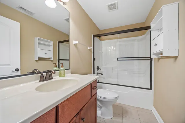 a view of a house with a yard and a bench