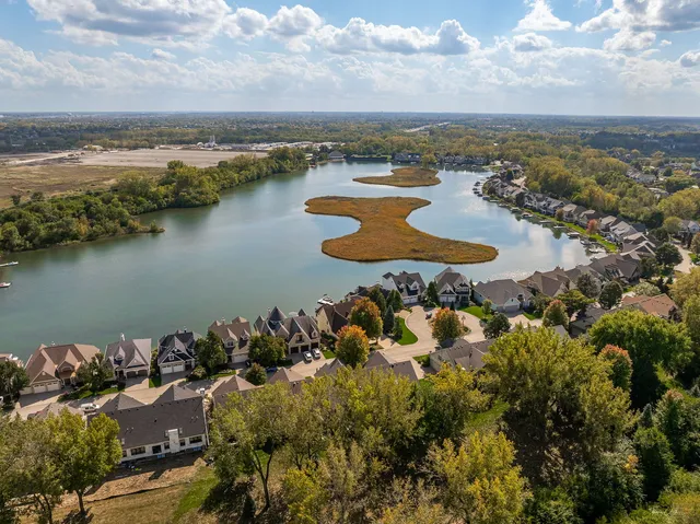 an aerial view of a houses with ocean view