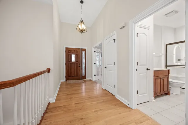 a view of a hallway view with wooden floor and staircase