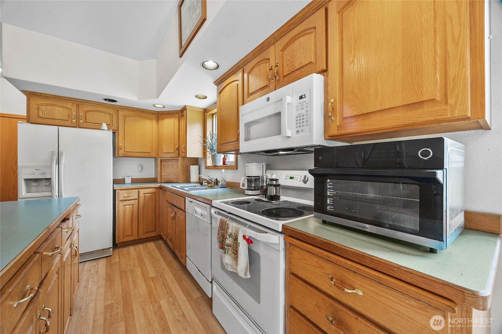 122 Ridge View Drive Randle, WA 98377 - Photo 13 of 40 a kitchen with stainless steel appliances granite countertop a stove a sink and a microwave