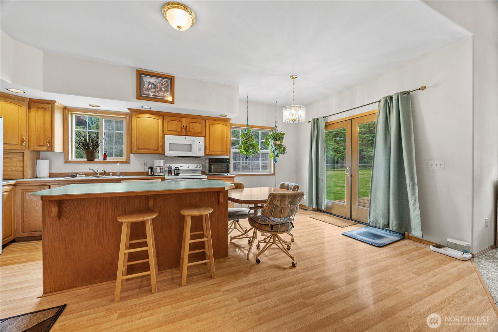 122 Ridge View Drive Randle, WA 98377 - Photo 9 of 40 a open kitchen with stainless steel appliances granite countertop a stove a sink dishwasher and white cabinets with wooden floor