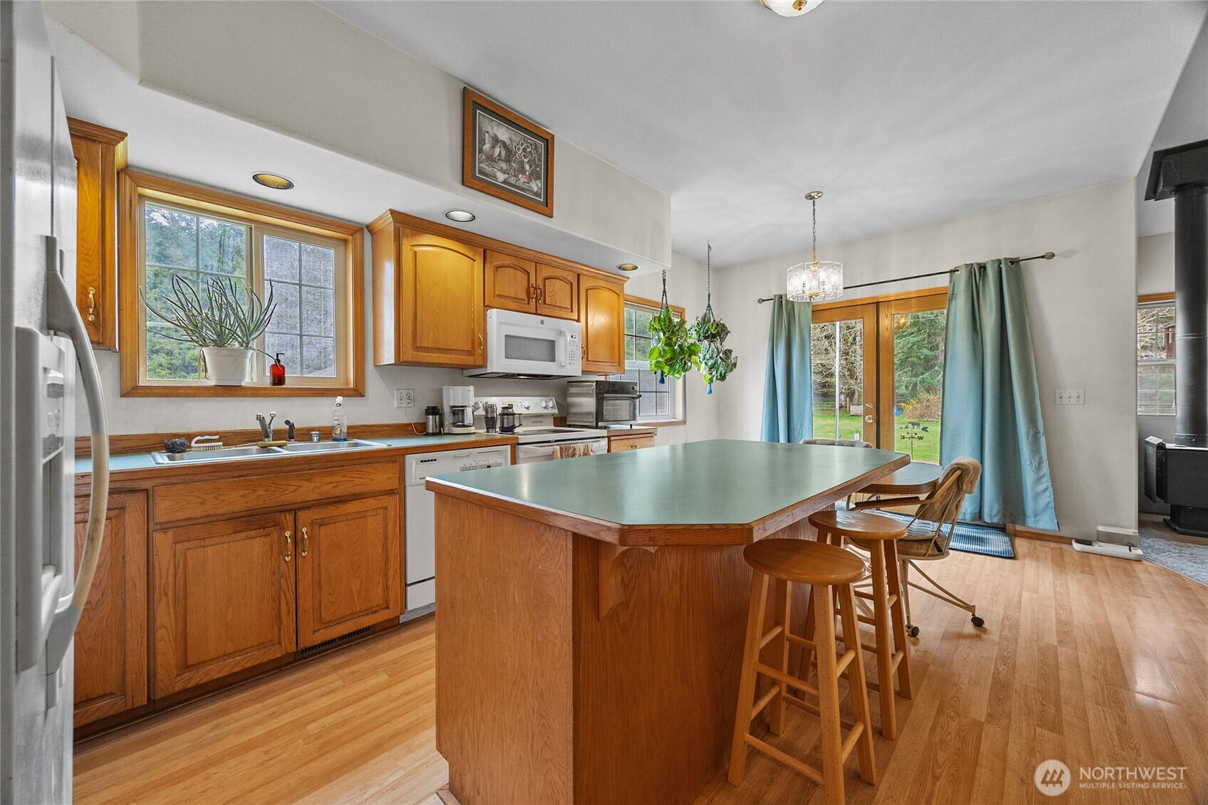 122 Ridge View Drive Randle, WA 98377 - Photo 10 of 40 a kitchen with stainless steel appliances granite countertop a stove a sink and a wooden cabinets