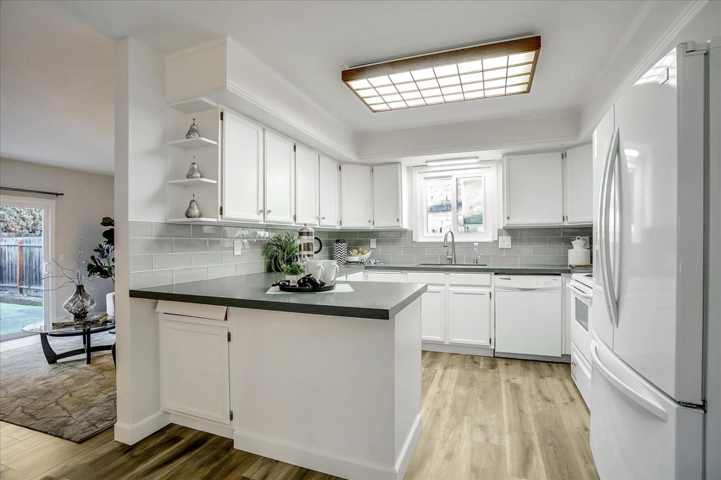 5282 Pebbletree Way San Jose, CA 95111 - Photo 15 of 39 a kitchen with stainless steel appliances granite countertop a sink cabinets and window