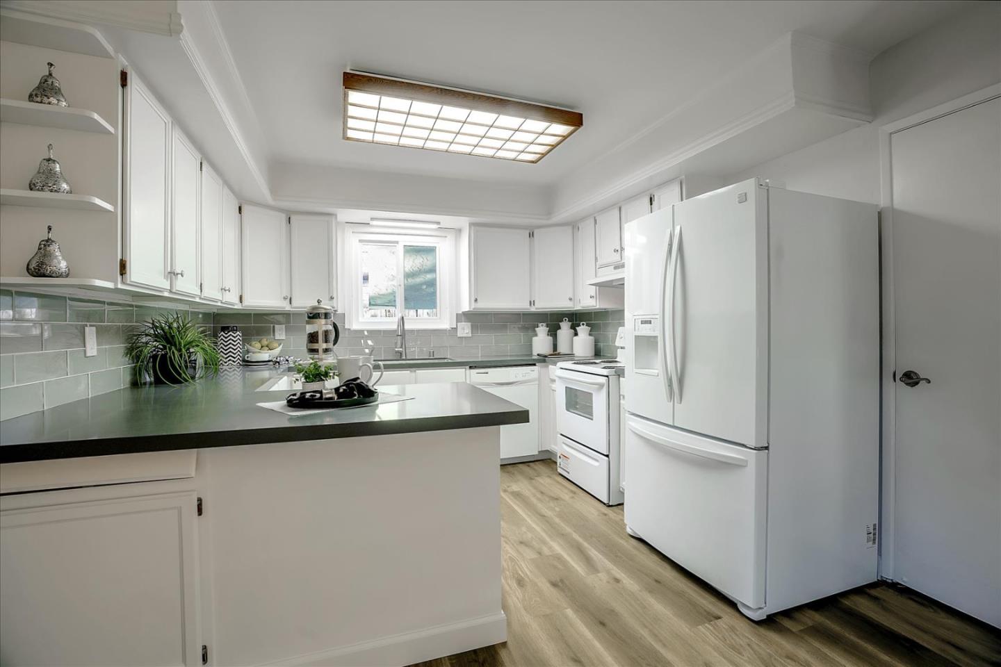 5282 Pebbletree Way San Jose, CA 95111 - Photo 16 of 39 a kitchen with white cabinets and white appliances