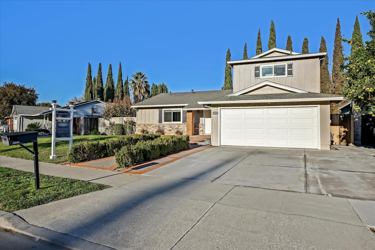 5282 Pebbletree Way San Jose, CA 95111 - Photo 4 of 39 a front view of a house with a yard and garage