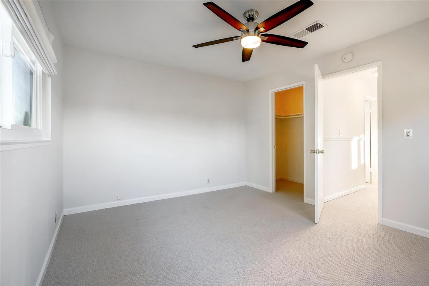 5282 Pebbletree Way San Jose, CA 95111 - Photo 34 of 39 an empty room with a ceiling fan and a window