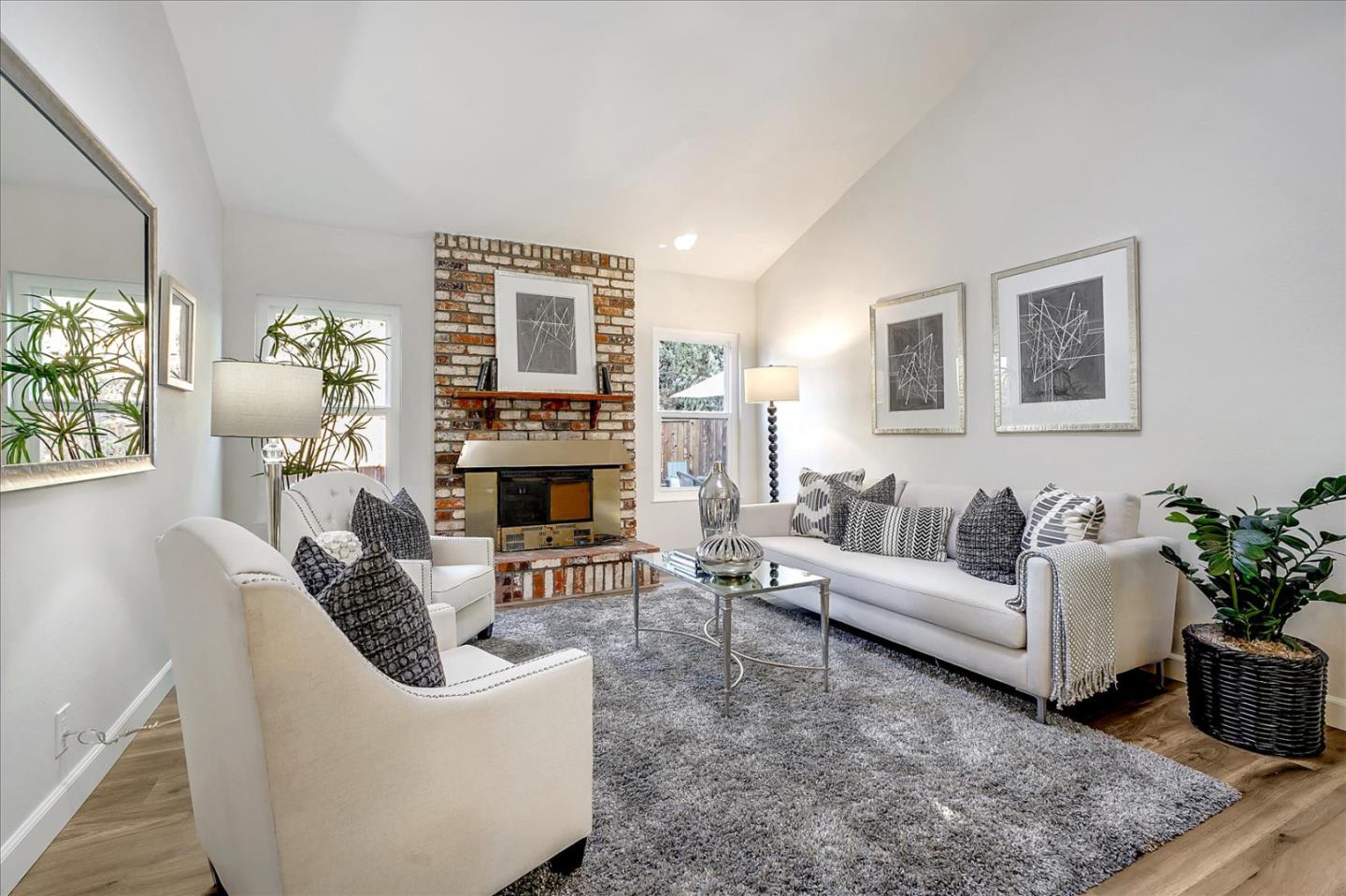 5282 Pebbletree Way San Jose, CA 95111 - Photo 9 of 39 a living room with furniture a fireplace and a potted plant