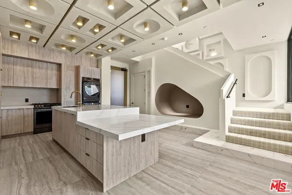 a kitchen with a stove a sink and a refrigerator