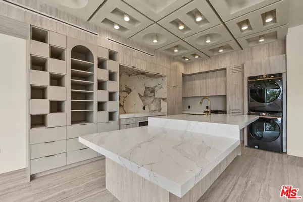 a large white kitchen with a large window