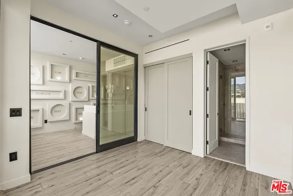 a view of a room with wooden floor and windows