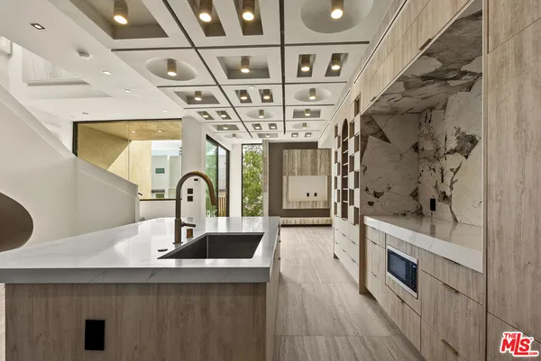 a kitchen with stainless steel appliances granite countertop a sink and a stove